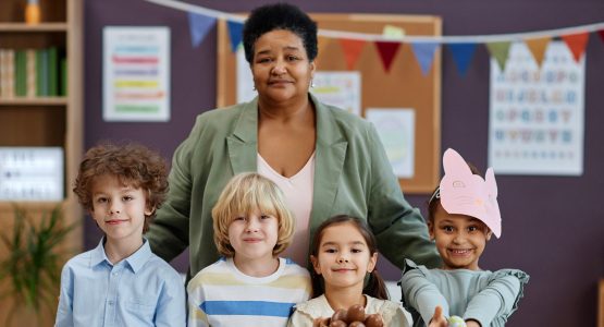 female-teacher-posing-with-diverse-group-of-childr-2023-11-27-05-08-06-utc-1.jpg