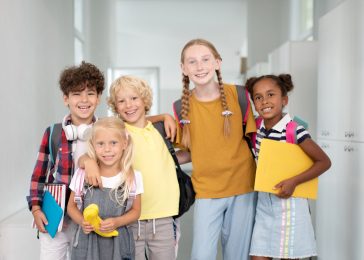 stylish-happy-pupils-standing-near-lockers-all-tog-2023-11-27-05-01-29-utc-1.jpg